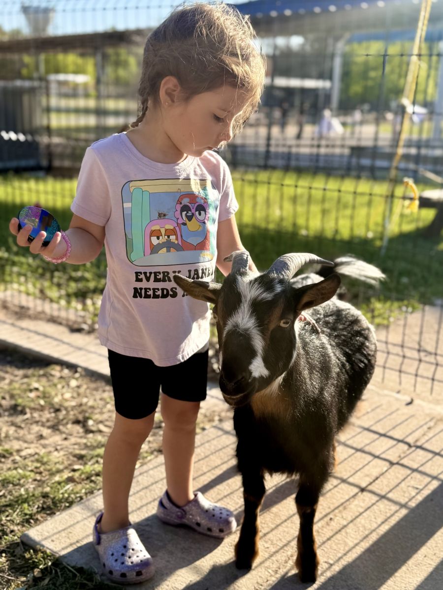 Blanton student with a goat at the Blanton Barn and Farm